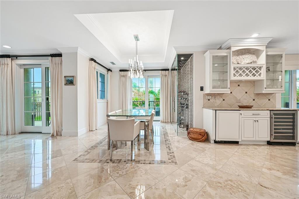 425 5th Street South, Unit A Naples, FL 34102 - Photo 10 of 44 a view of a dining room with furniture window and outside view