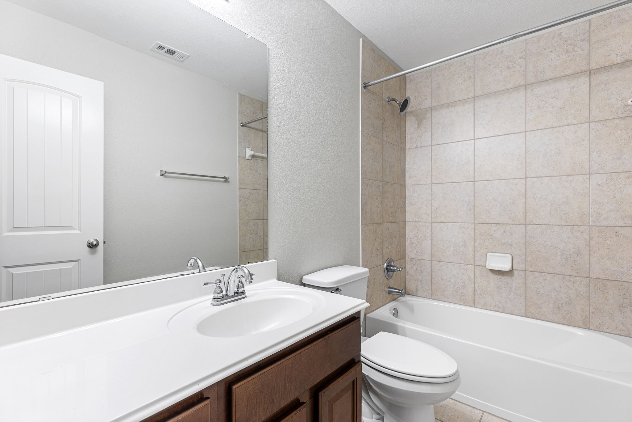 237 Cardinal Drive Paige, TX 78659 - Photo 25 of 37 Bathroom with vanity, washtub / shower combination, and a textured wall