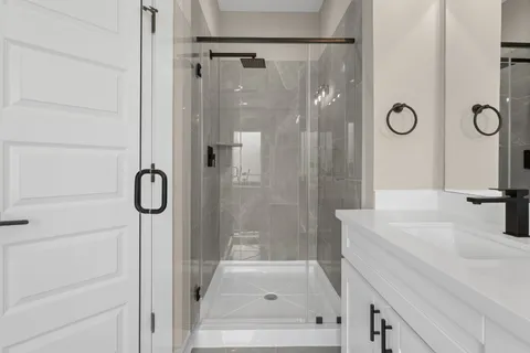 a bathroom with a double vanity sink and mirror