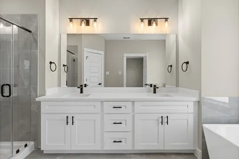 a bathroom with a shower sink double and mirror