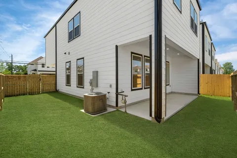 a view of a porch with a big yard and floor to ceiling window