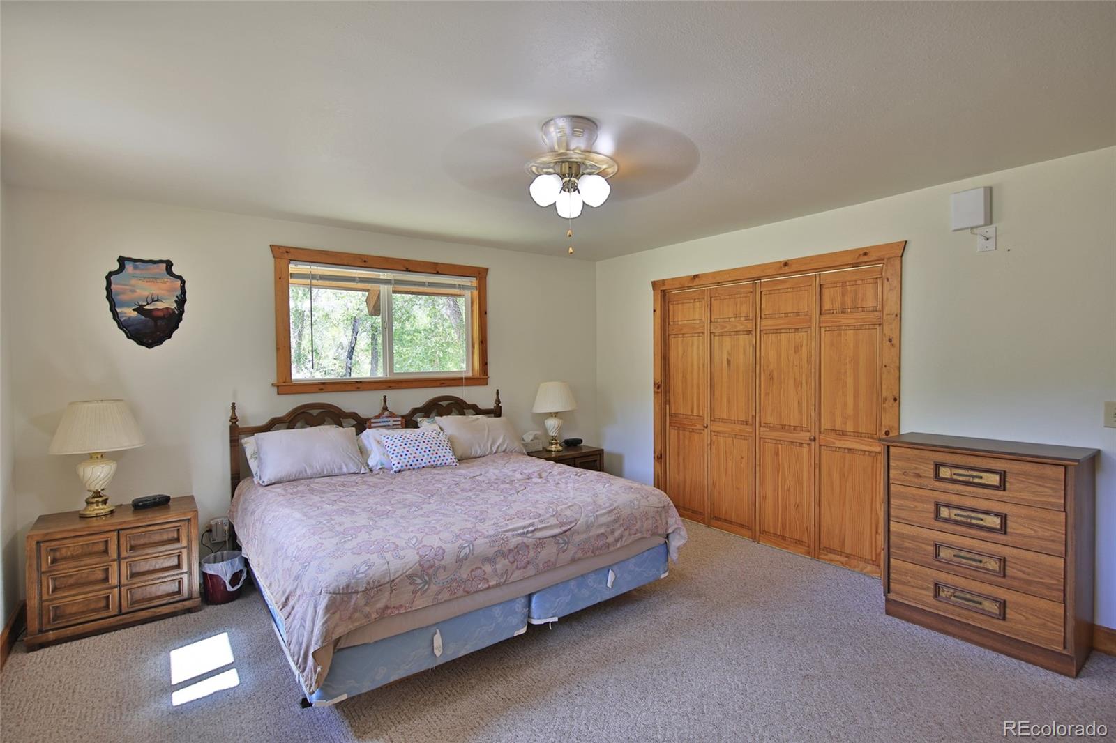 9681-56 56 2/10 Road Molina, CO 81646 - Photo 19 of 39 a bedroom with a bed and a dresser with the balcony