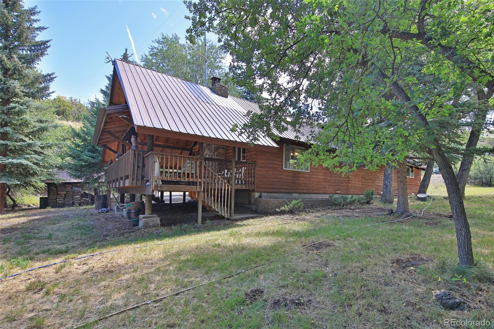 9681-56 56 2/10 Road Molina, CO 81646 - Photo 27 of 39 a view of a house with a yard porch and sitting area