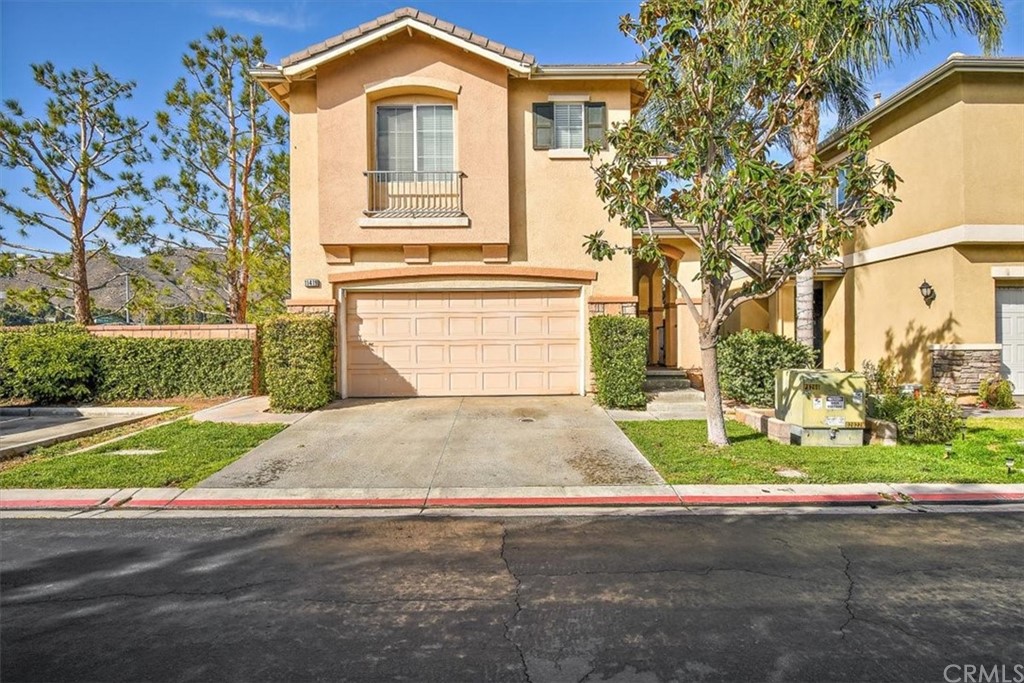11419 Brookscape Lane Riverside, CA 92505 - Photo 1 of 1 a front view of a house with a yard and garage
