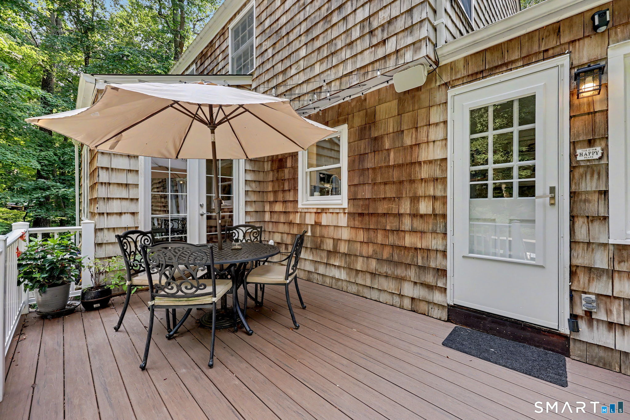 241 Mountain Road Wilton, CT 06897 - Photo 26 of 32 New Trex deck provides a low-maintenance outdoor space for dining, entertaining and enjoying the private, wooded setting.