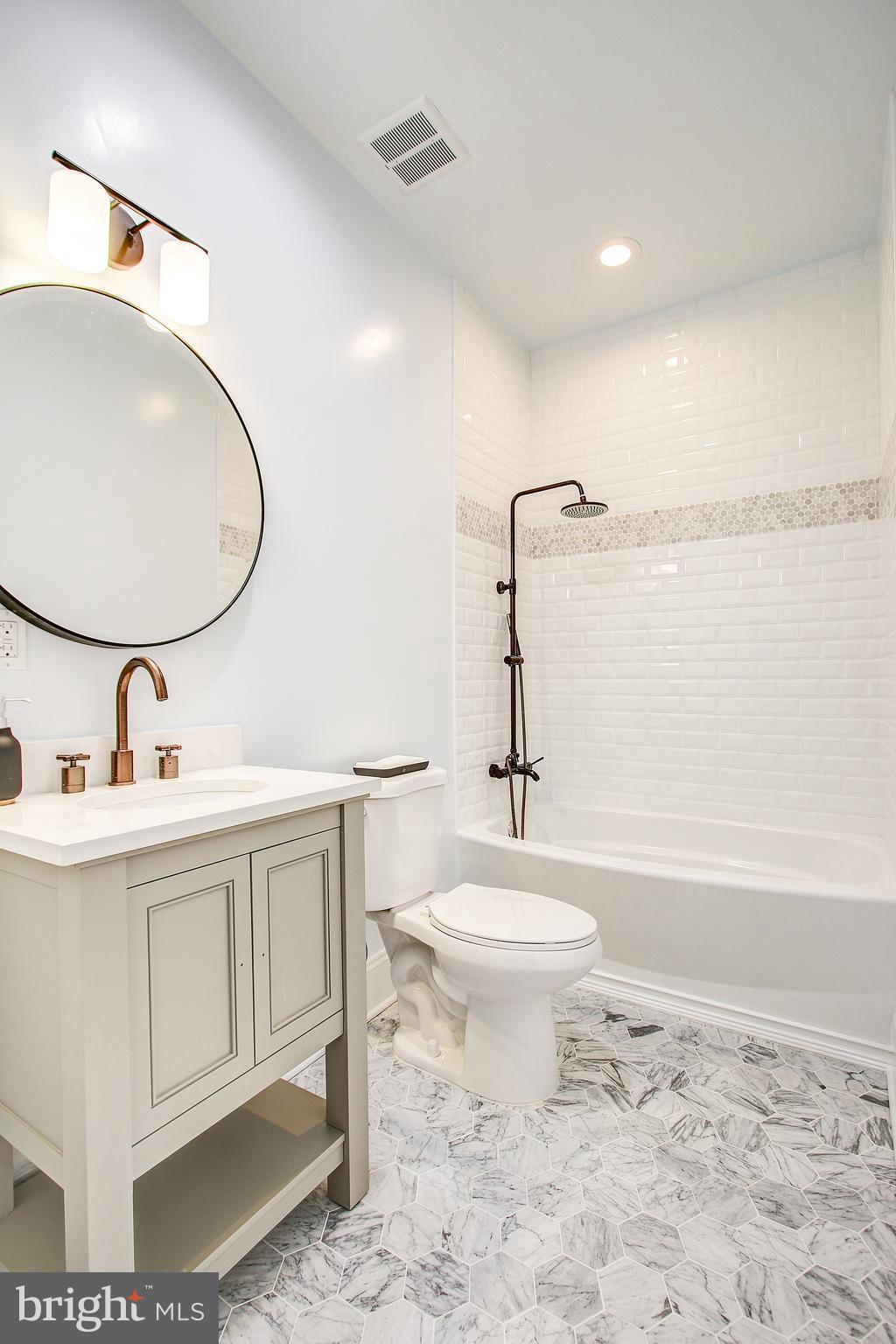 1723 U Street Northwest, Unit 3 Washington, DC 20009 - Photo 11 of 28 a bathroom with a toilet sink and mirror