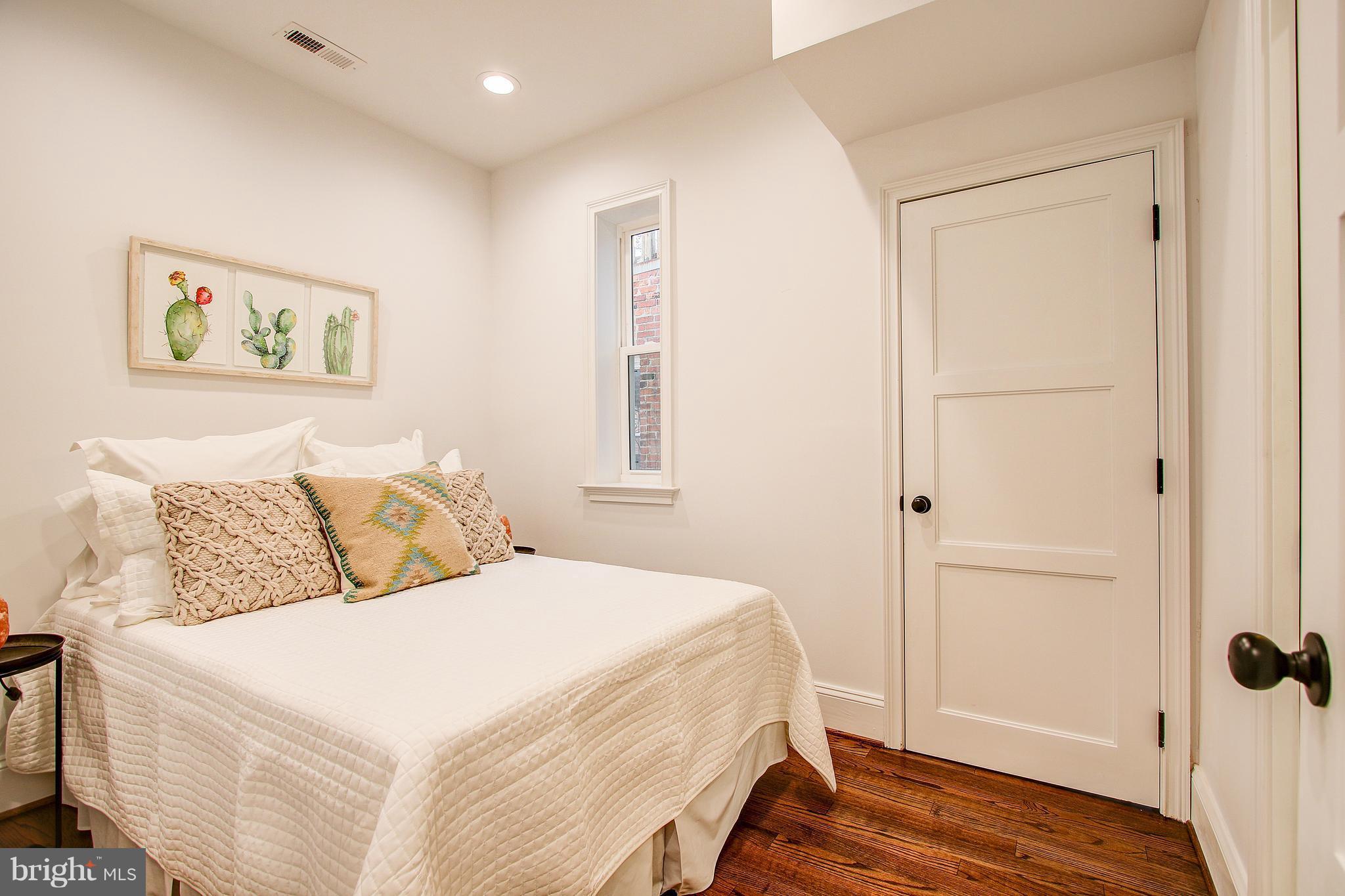 1723 U Street Northwest, Unit 3 Washington, DC 20009 - Photo 12 of 28 a bedroom with a bed and a window