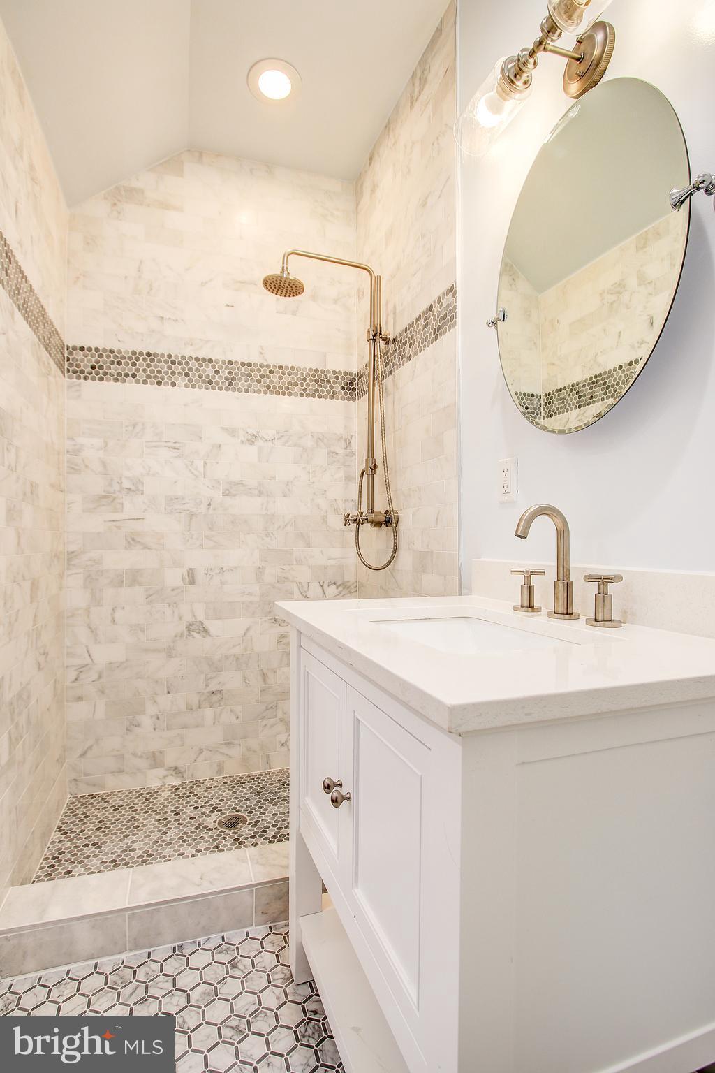 1723 U Street Northwest, Unit 3 Washington, DC 20009 - Photo 16 of 28 a bathroom with a sink mirror and a shower