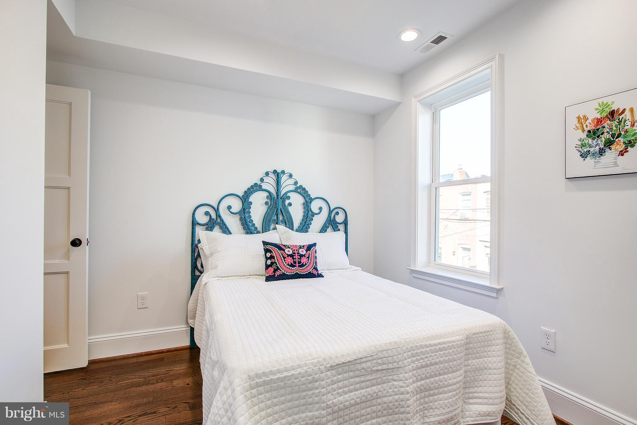 1723 U Street Northwest, Unit 3 Washington, DC 20009 - Photo 19 of 28 a bedroom with a bed and wooden floor
