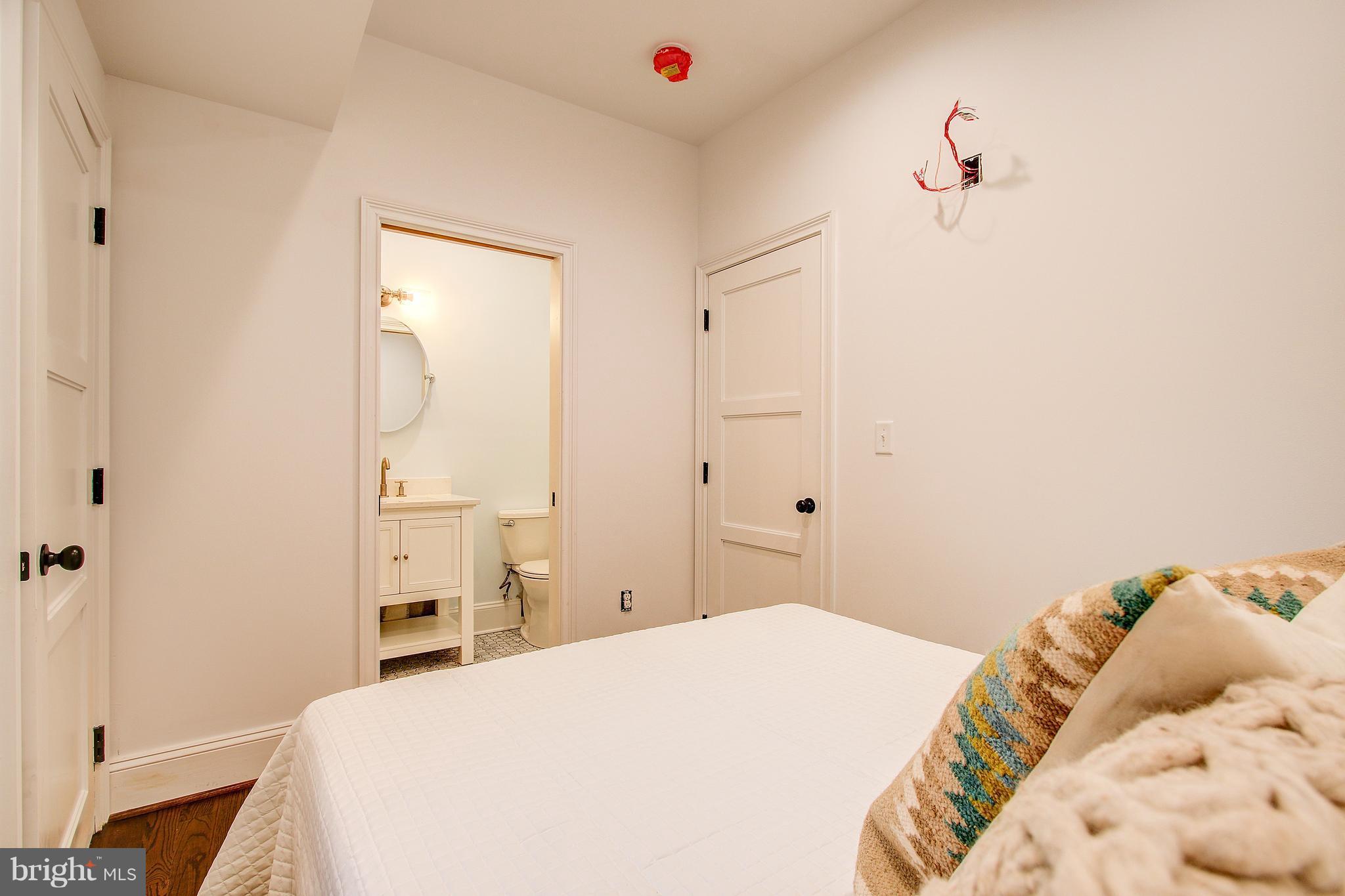 1723 U Street Northwest, Unit 3 Washington, DC 20009 - Photo 26 of 28 a bedroom with a bed and a chandelier