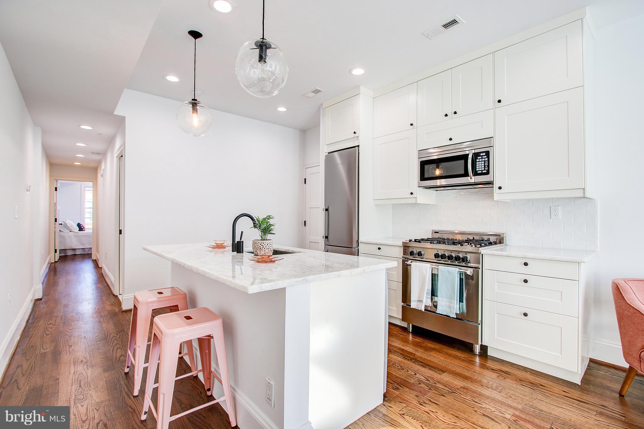 1723 U Street Northwest, Unit 3 Washington, DC 20009 - Photo 4 of 28 a kitchen with stainless steel appliances a sink stove and refrigerator