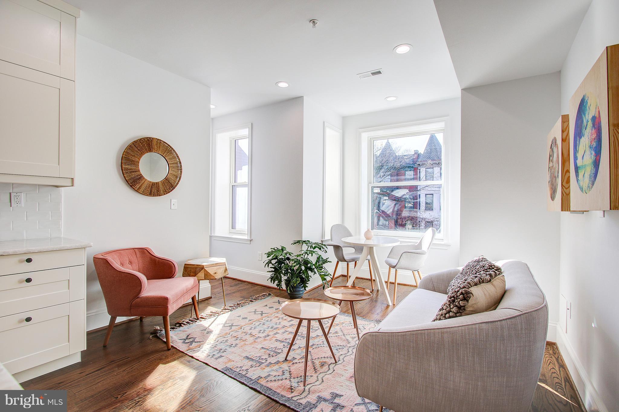 1723 U Street Northwest, Unit 3 Washington, DC 20009 - Photo 7 of 28 a living room with furniture and a large window