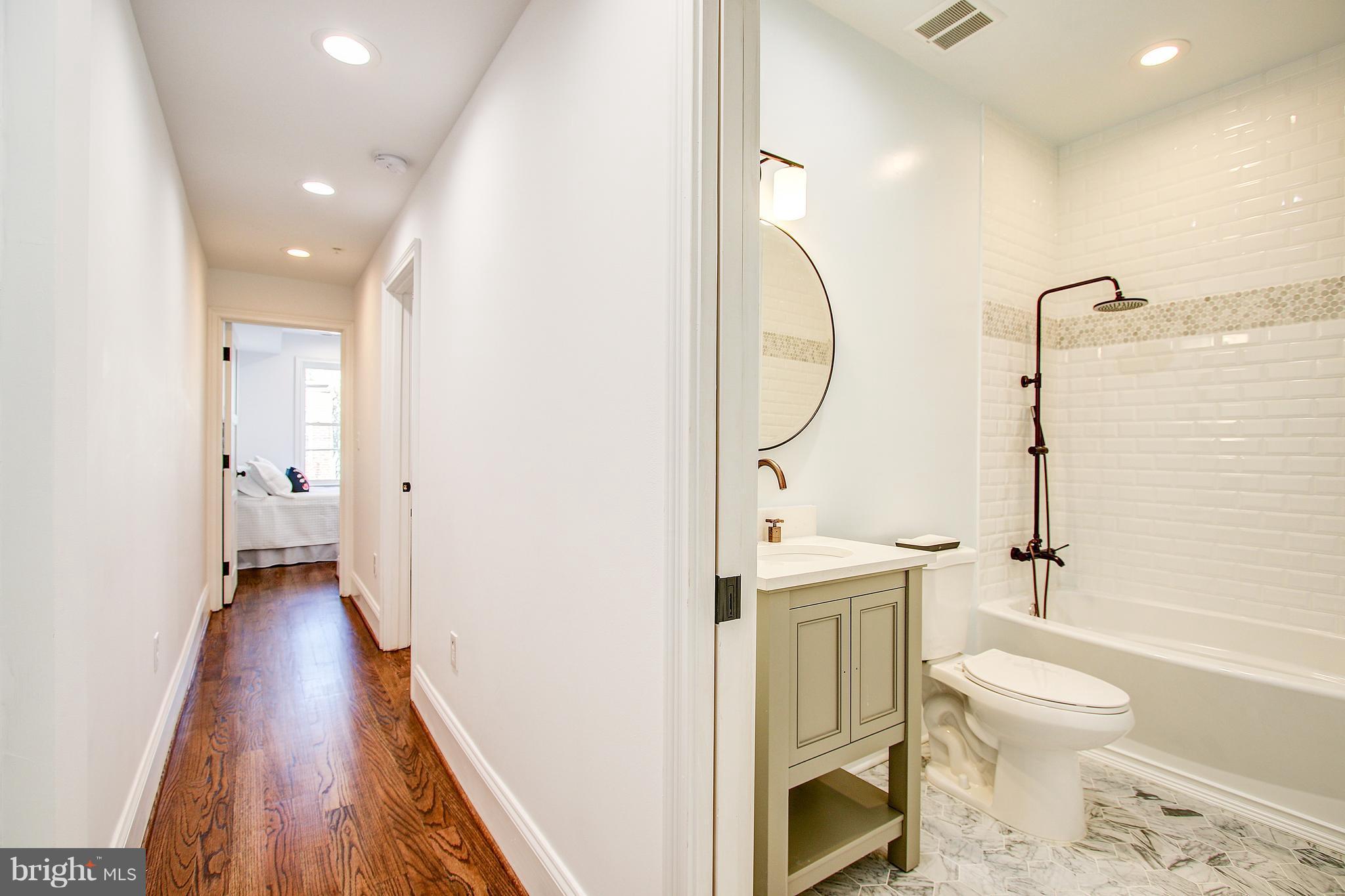1723 U Street Northwest, Unit 3 Washington, DC 20009 - Photo 10 of 28 a bathroom with a toilet sink and a mirror