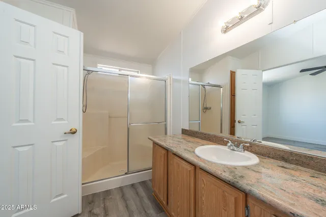 a bathroom with a granite countertop sink and a mirror