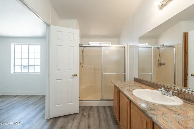 a bathroom with a granite countertop sink mirror and double