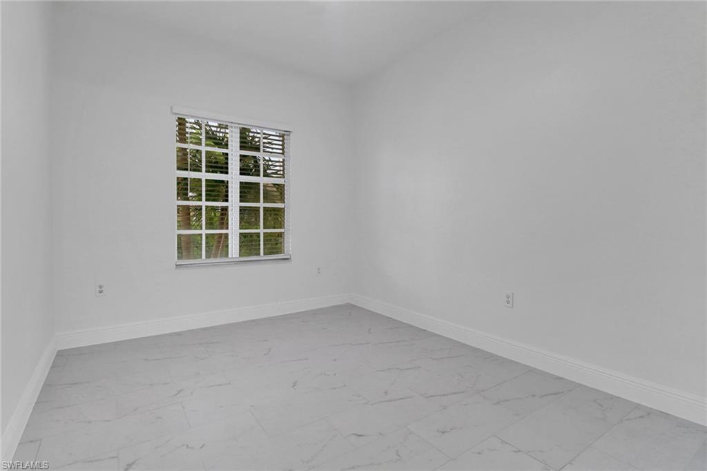 20170 Estero Gardens Circle, Unit 107 Estero, FL 33928 - Photo 14 of 44 an empty room with a window