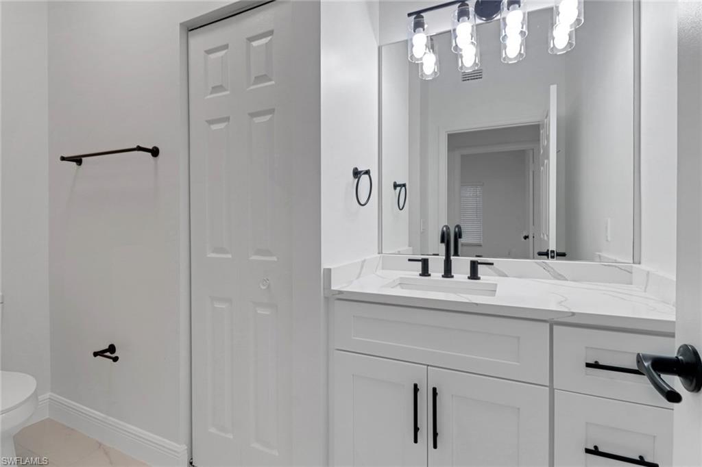 20170 Estero Gardens Circle, Unit 107 Estero, FL 33928 - Photo 16 of 44 a bathroom with a sink a toilet and shower