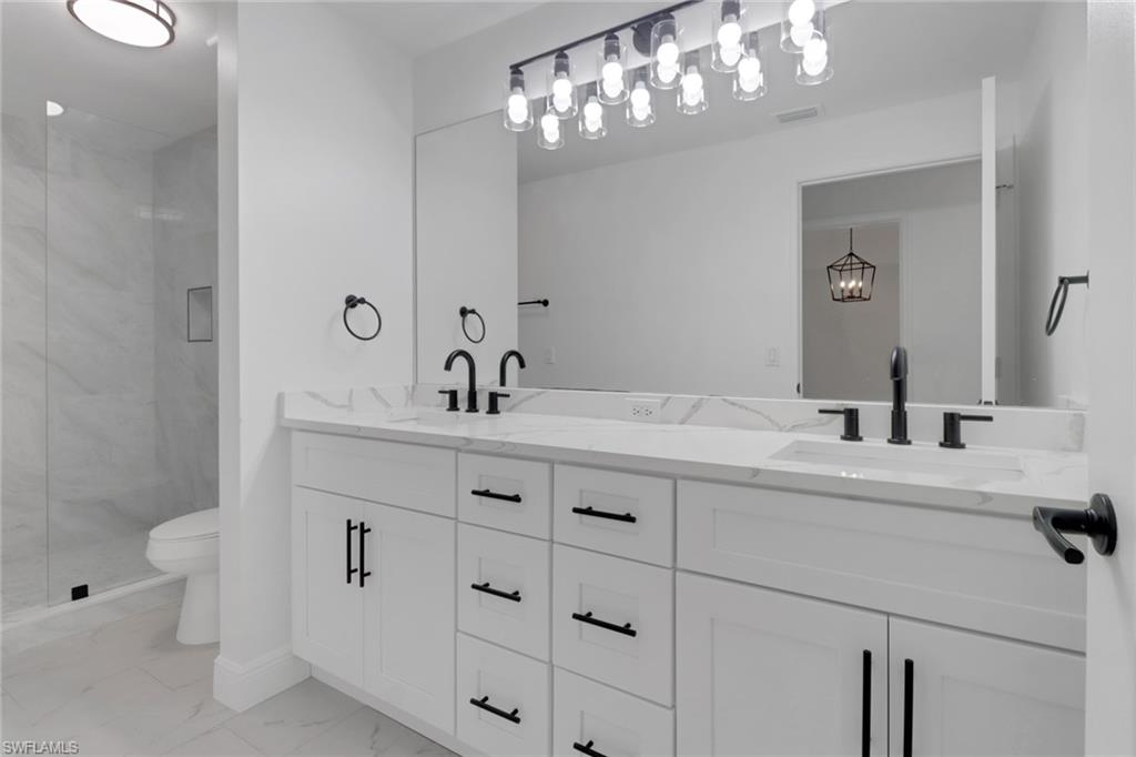 20170 Estero Gardens Circle, Unit 107 Estero, FL 33928 - Photo 20 of 44 a bathroom with a sink and a mirror