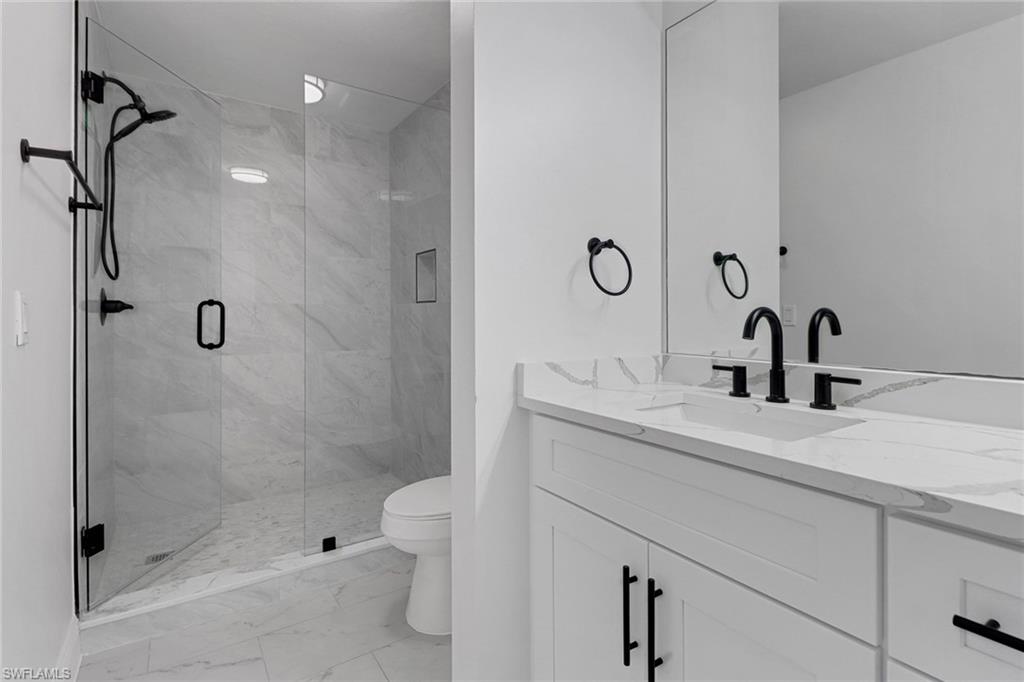20170 Estero Gardens Circle, Unit 107 Estero, FL 33928 - Photo 21 of 44 a bathroom with a sink a toilet and shower