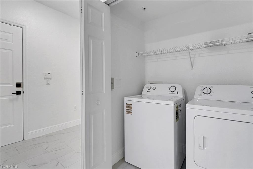 20170 Estero Gardens Circle, Unit 107 Estero, FL 33928 - Photo 22 of 44 a utility room with dryer and washer