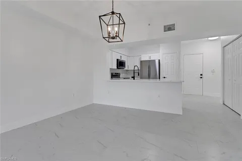 a view of a kitchen with a sink and cabinet area