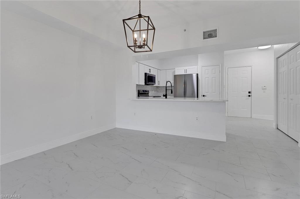 20170 Estero Gardens Circle, Unit 107 Estero, FL 33928 - Photo 9 of 44 a view of a kitchen with a sink and cabinet area