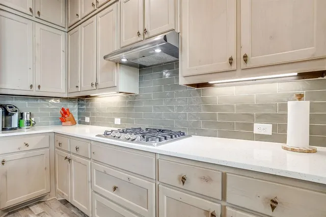 a kitchen with white cabinets and white appliances