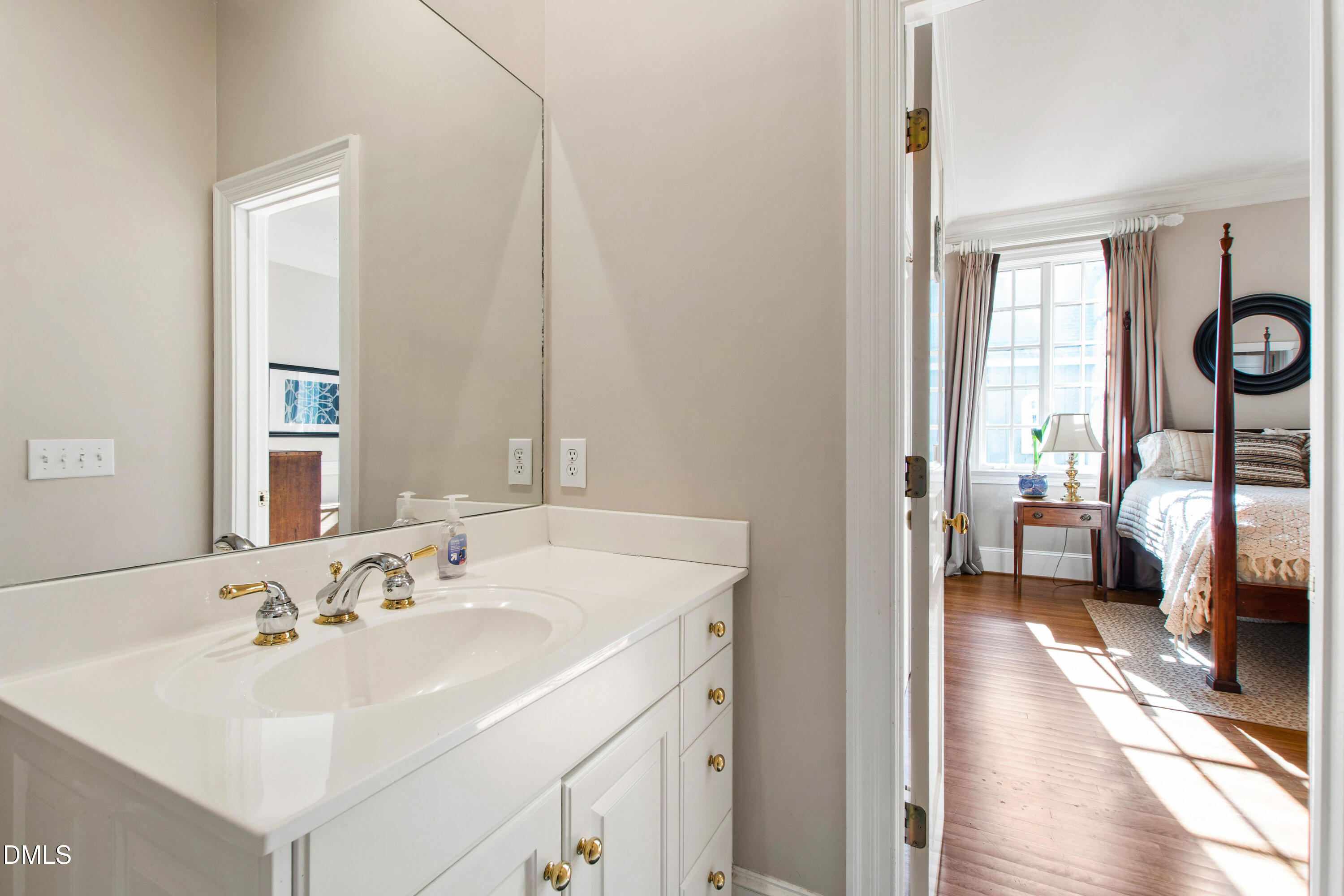 2536 Wake Drive Raleigh, NC 27608 - Photo 28 of 74 a en suite bathroom with a sink and a mirror