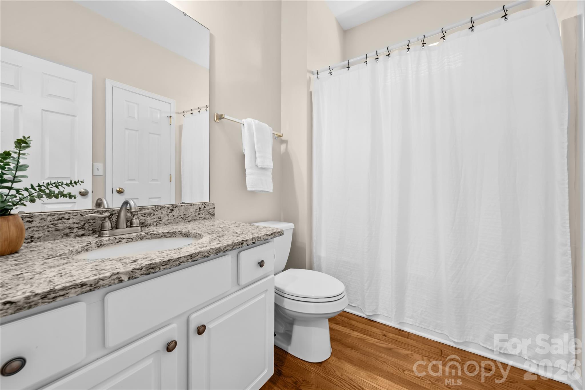 13338 Fremington Road Huntersville, NC 28078 - Photo 18 of 34 a bathroom with a granite countertop sink and a mirror