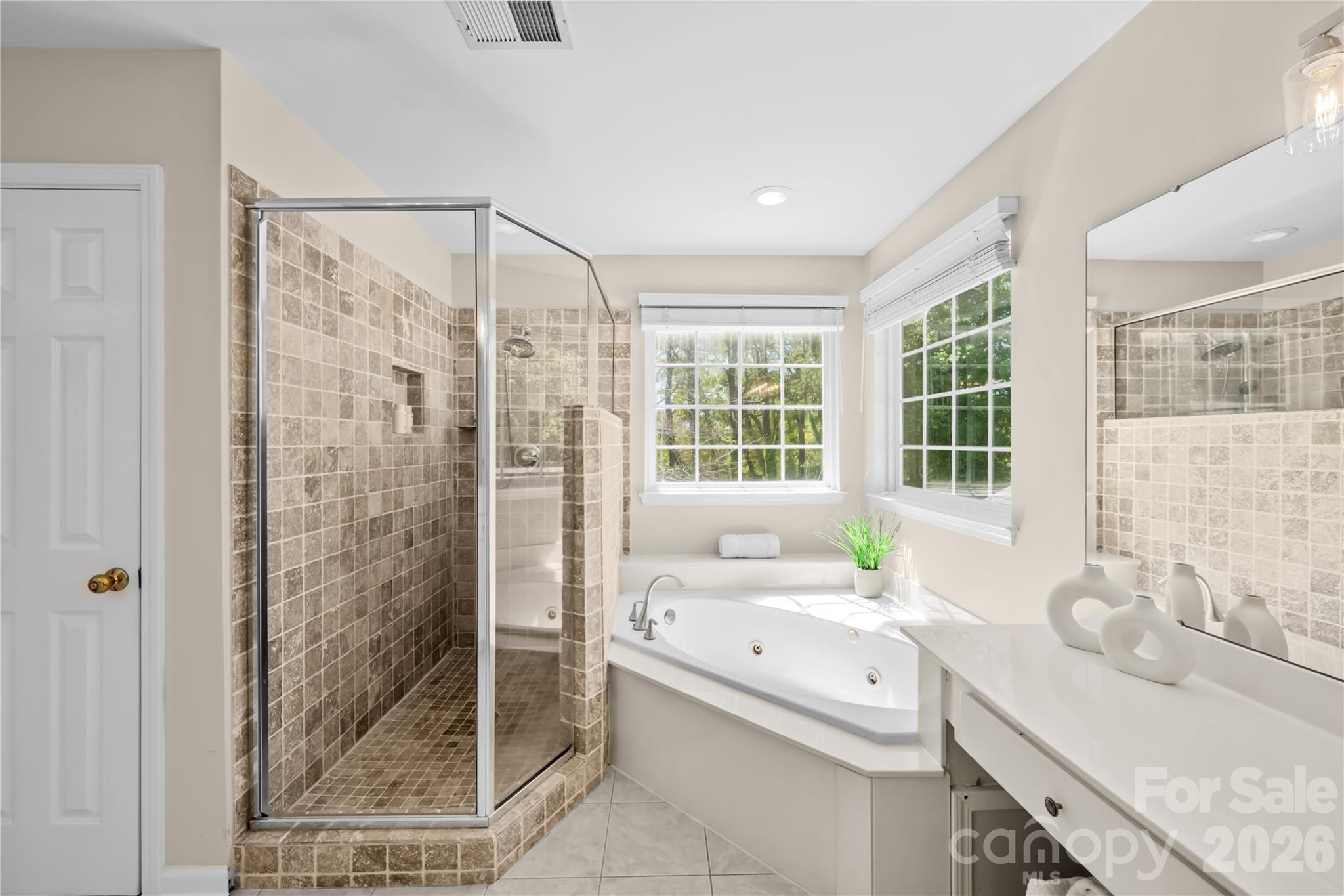 13338 Fremington Road Huntersville, NC 28078 - Photo 22 of 34 a bathroom with a granite countertop sink a large mirror and shower