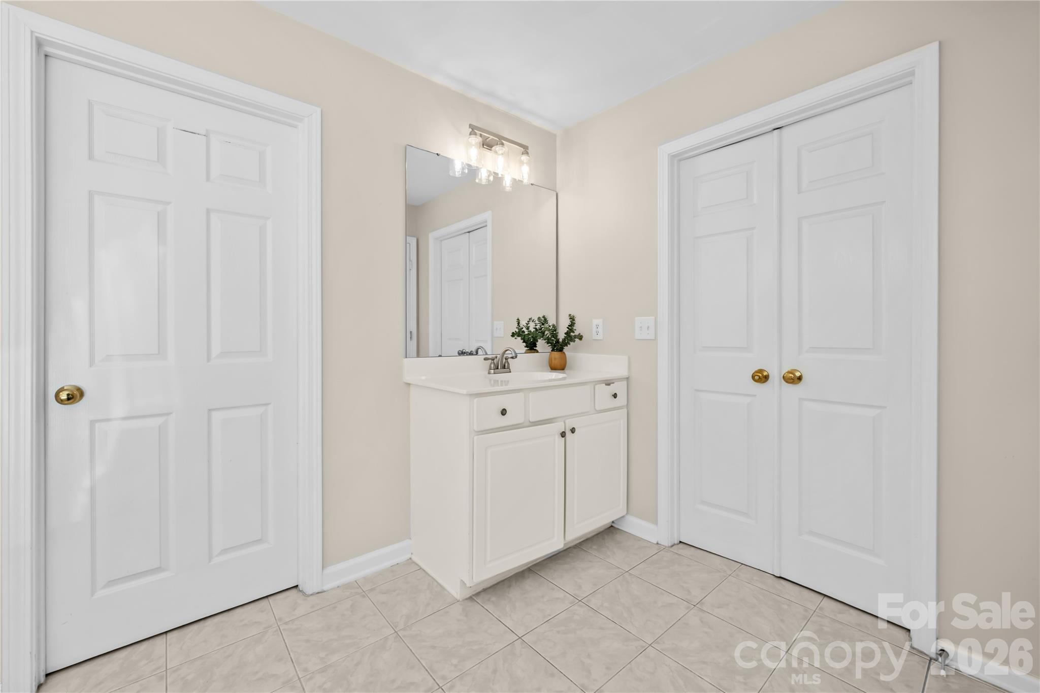 13338 Fremington Road Huntersville, NC 28078 - Photo 24 of 34 a bathroom with a sink a mirror and a shower