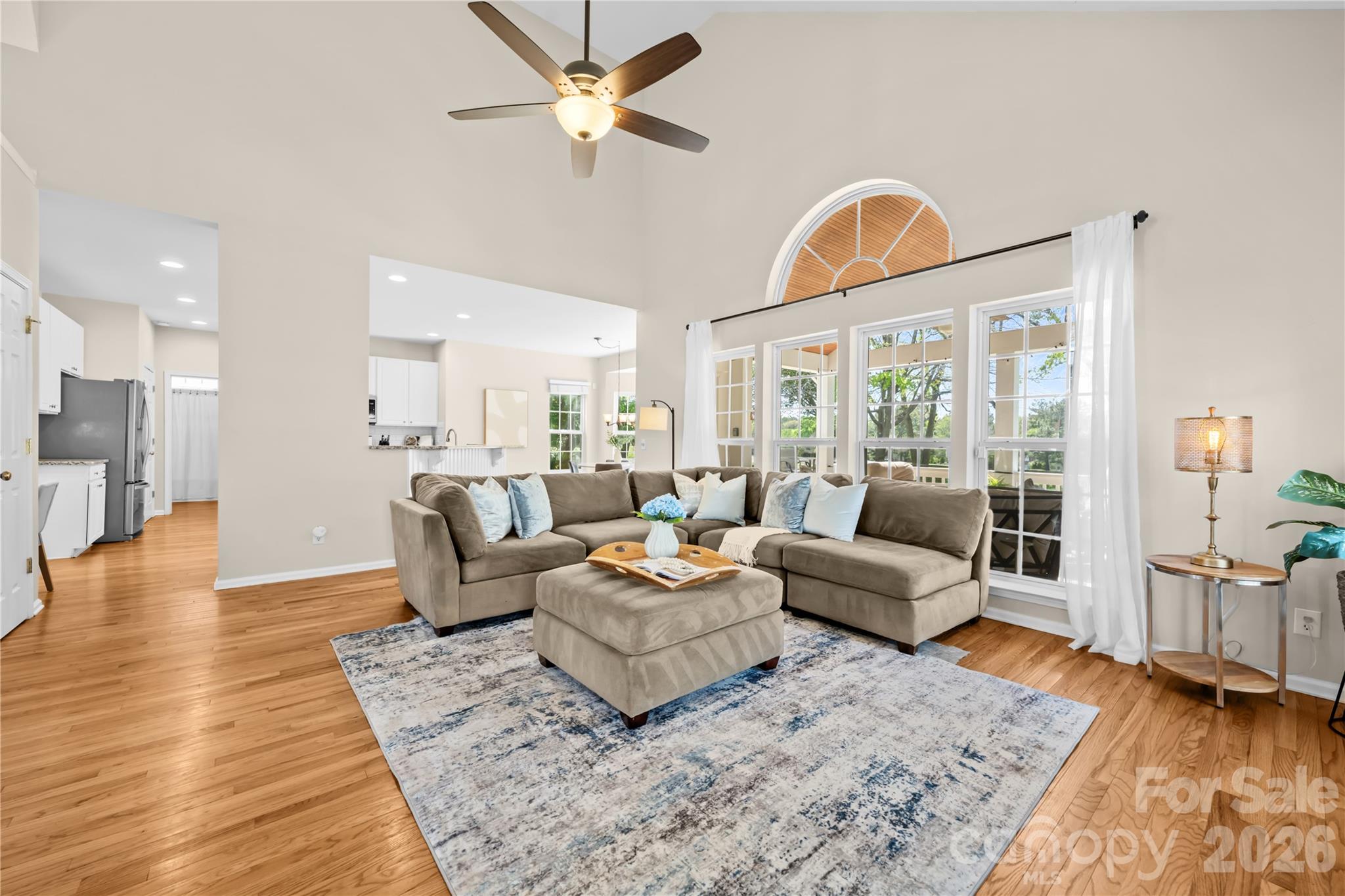 13338 Fremington Road Huntersville, NC 28078 - Photo 8 of 34 a living room with furniture a wooden floor and a chandelier