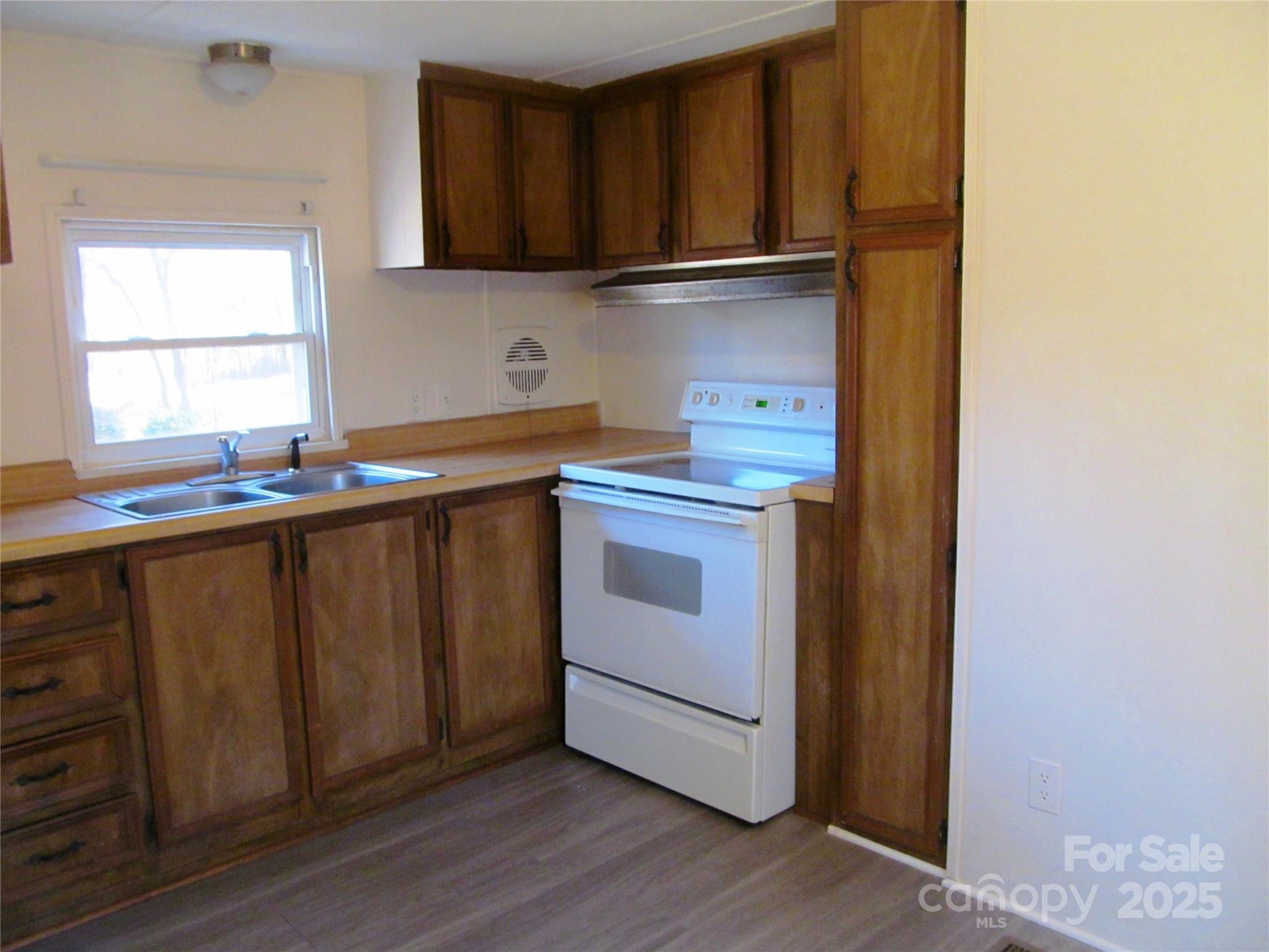 1054 Stirewalt Road, Unit 6 China Grove, NC 28023 - Photo 3 of 10 a kitchen with stainless steel appliances granite countertop a sink and a stove