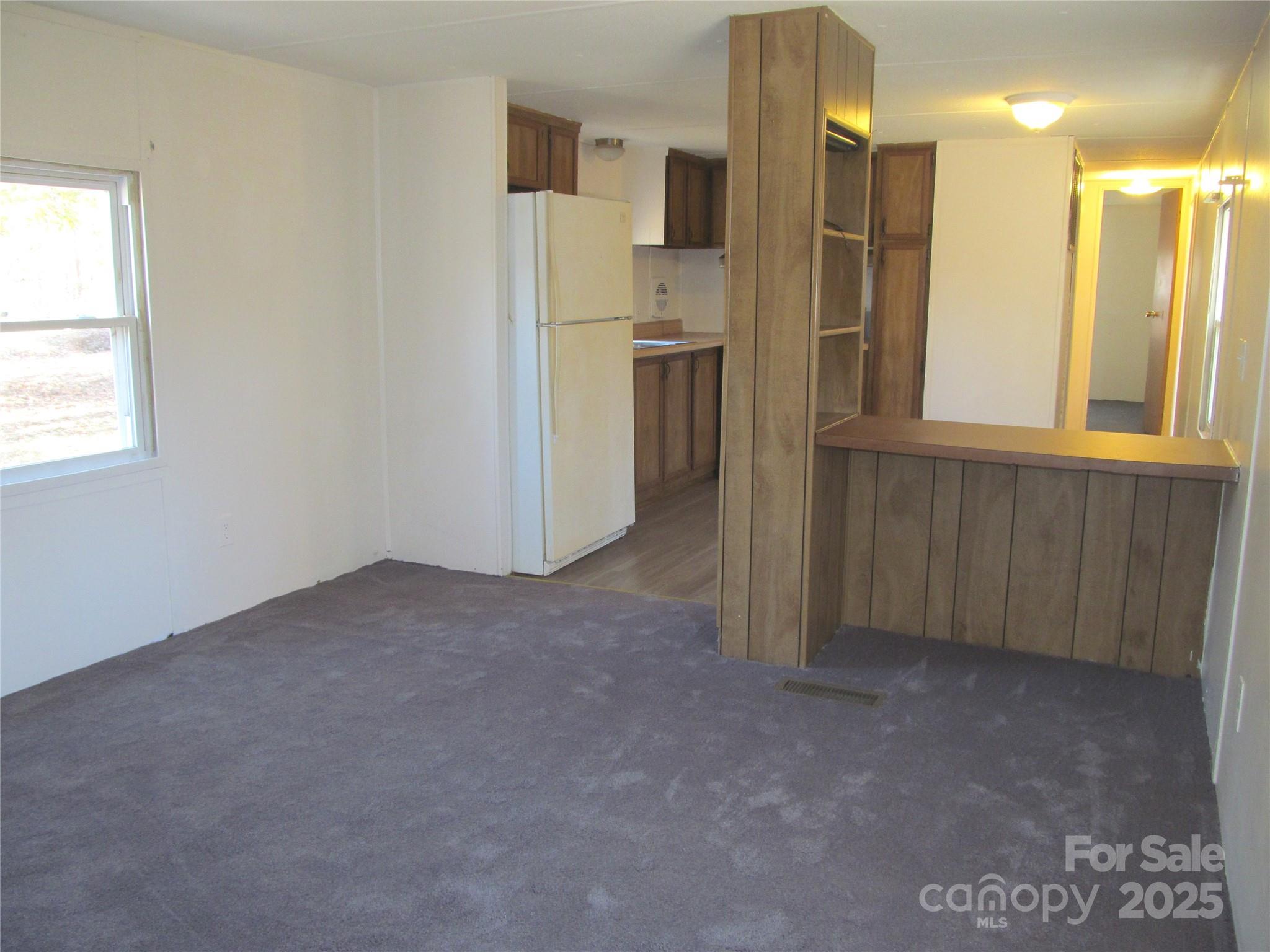 1054 Stirewalt Road, Unit 6 China Grove, NC 28023 - Photo 4 of 10 a view of a kitchen with a refrigerator and cabinets