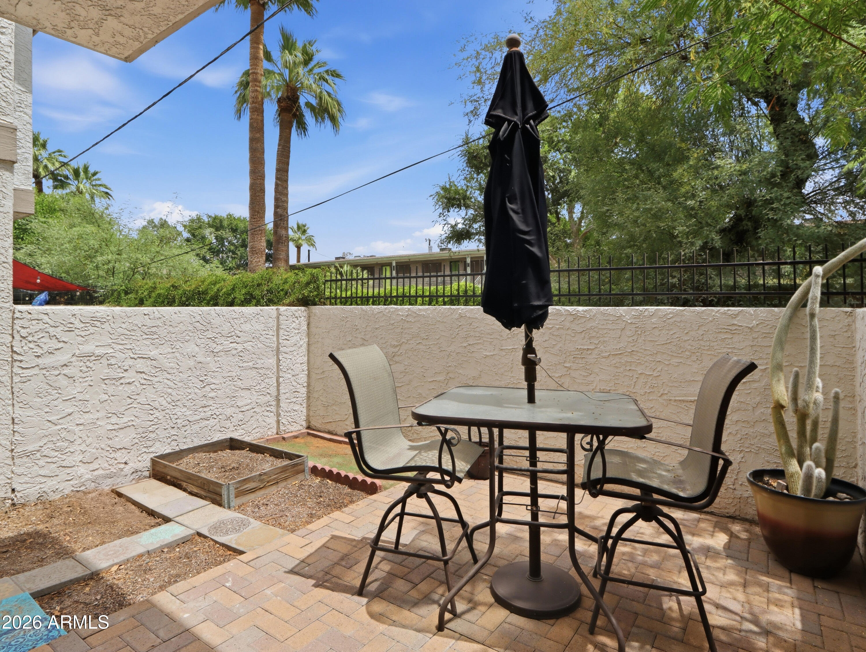 1402 East Osborn Road, Unit 2 Phoenix, AZ 85014 - Photo 20 of 29 a table and chairs in front of a house