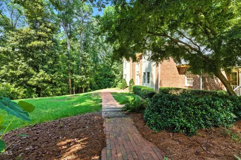 a view of a dining room with furniture a chandelier and wooden floor