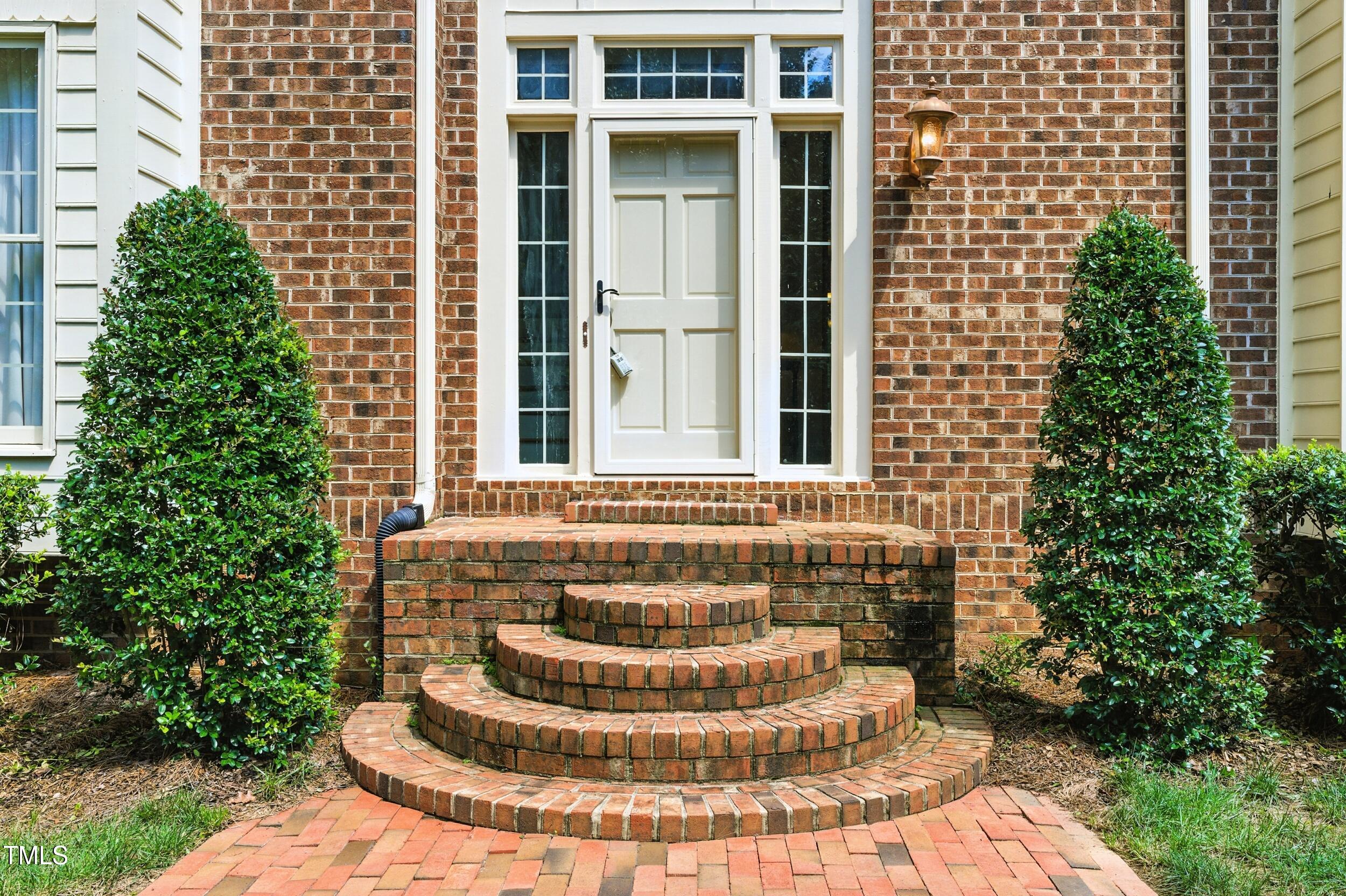 5317 Deep Valley Raleigh, NC 27606 - Photo 14 of 59 a view of a brick house with a fountain