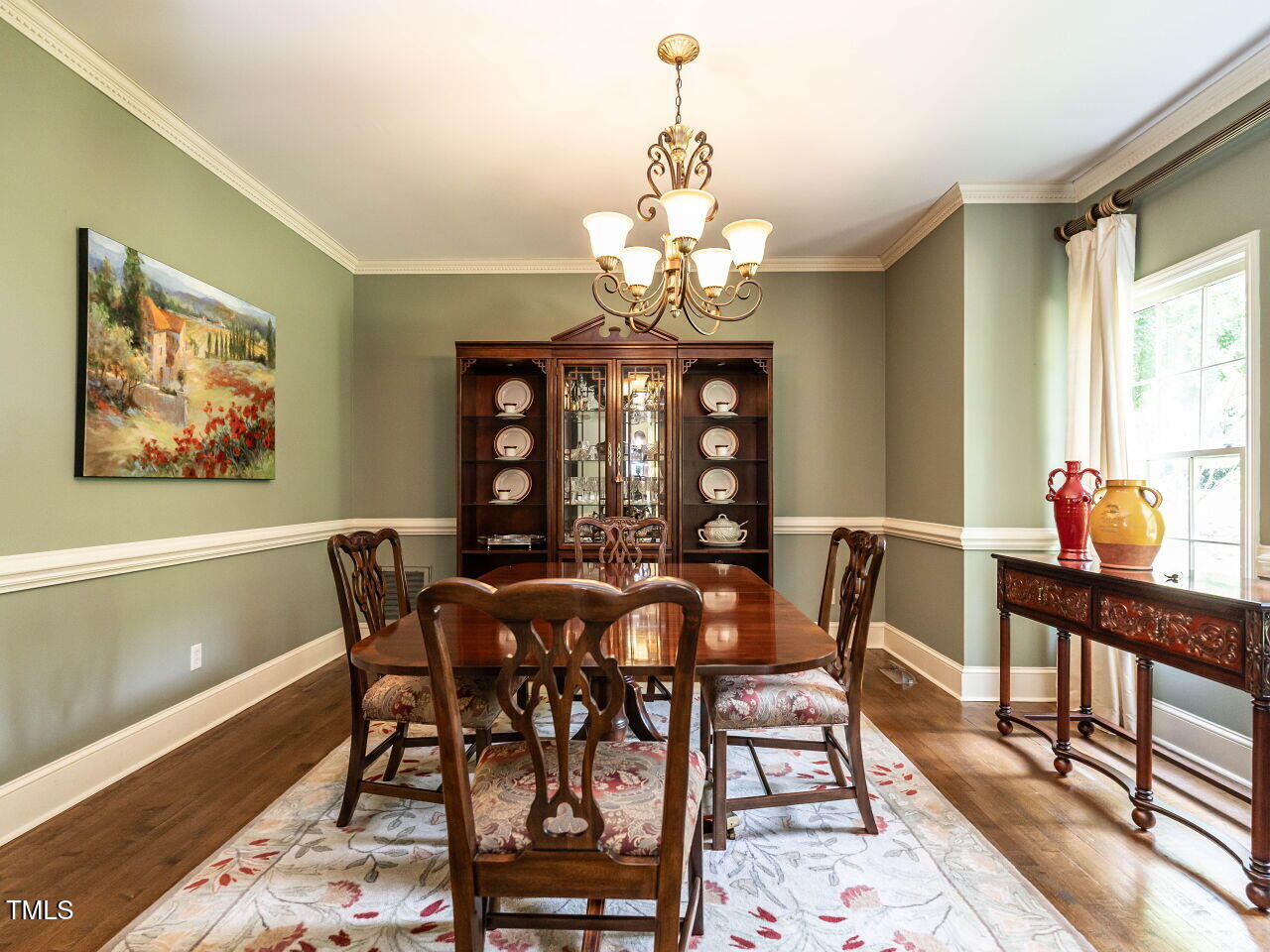 5317 Deep Valley Raleigh, NC 27606 - Photo 15 of 59 a view of a dining room with furniture a chandelier and wooden floor