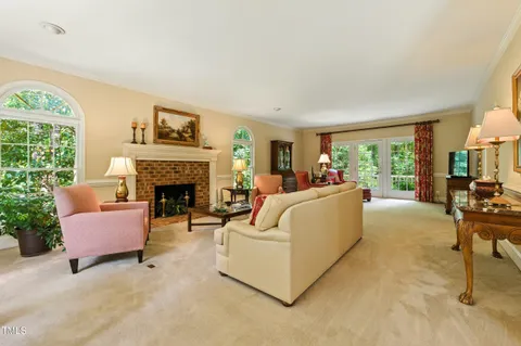 a kitchen with stainless steel appliances granite countertop a stove top oven a sink a dining table and chairs with wooden floor