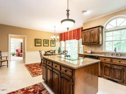 a view of patio with chairs and table under an umbrella