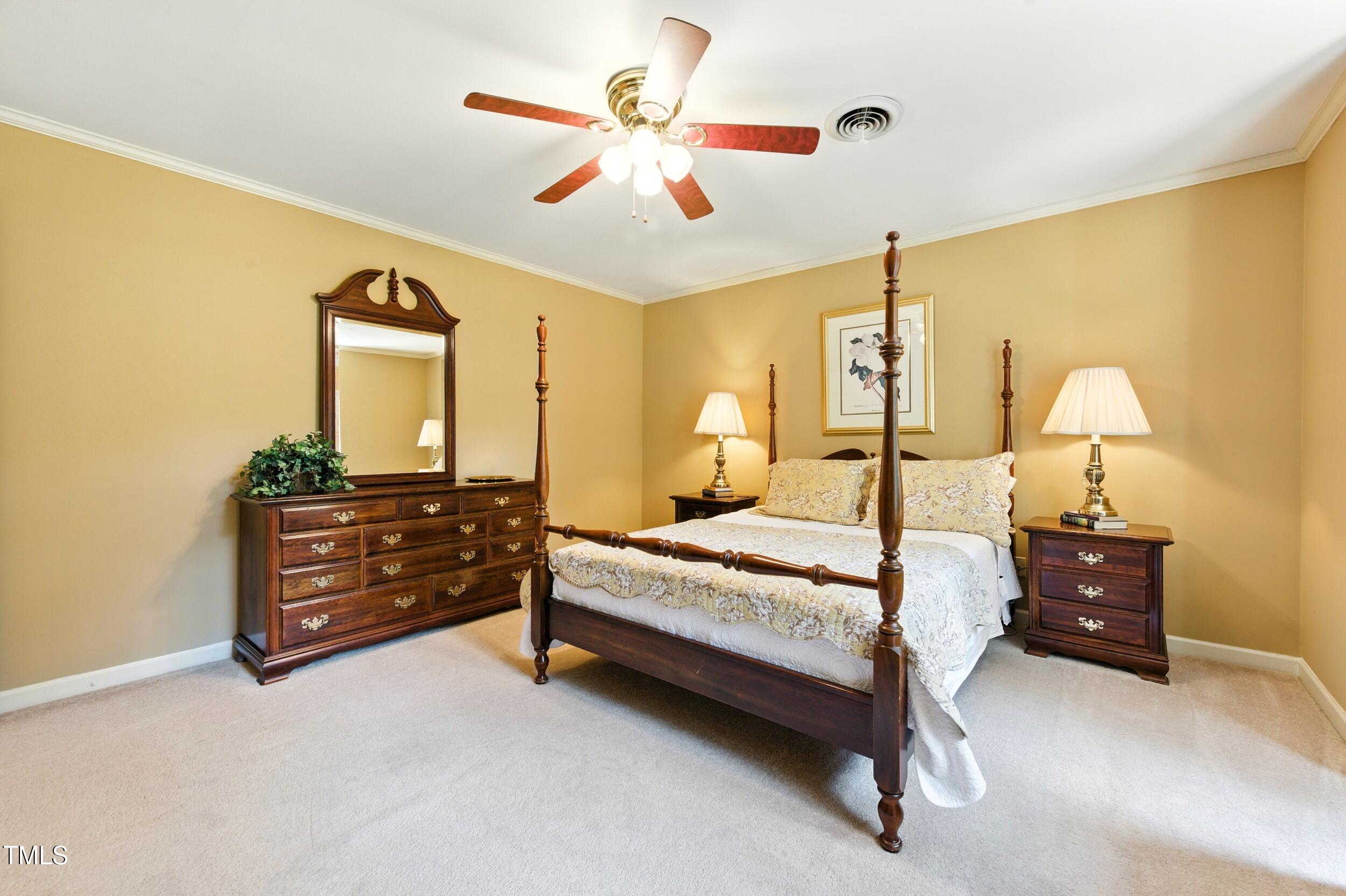 5317 Deep Valley Raleigh, NC 27606 - Photo 35 of 59 a bedroom with a bed and a chandelier