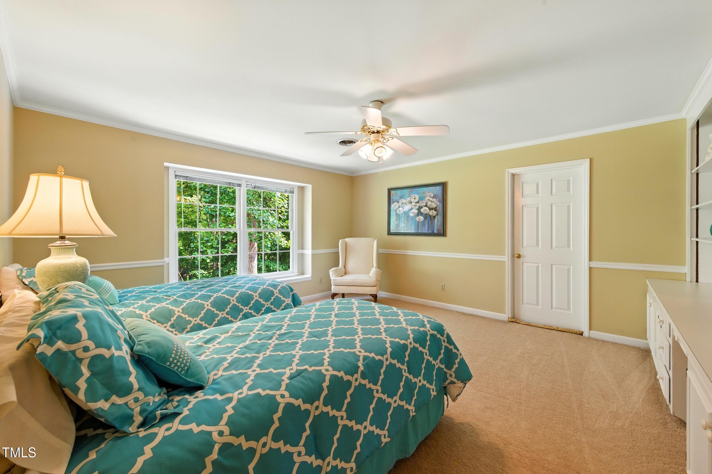 5317 Deep Valley Raleigh, NC 27606 - Photo 37 of 59 a bedroom with a bed and a window