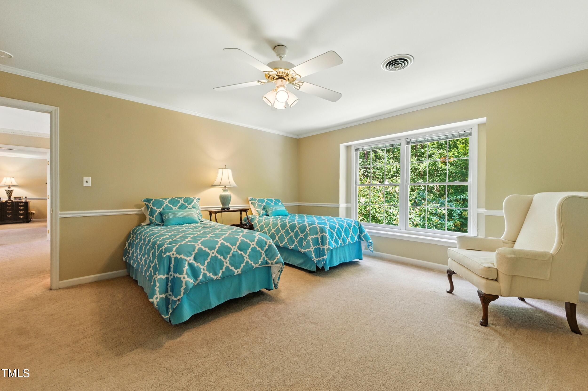 5317 Deep Valley Raleigh, NC 27606 - Photo 38 of 59 a living room with two bed and a chandelier
