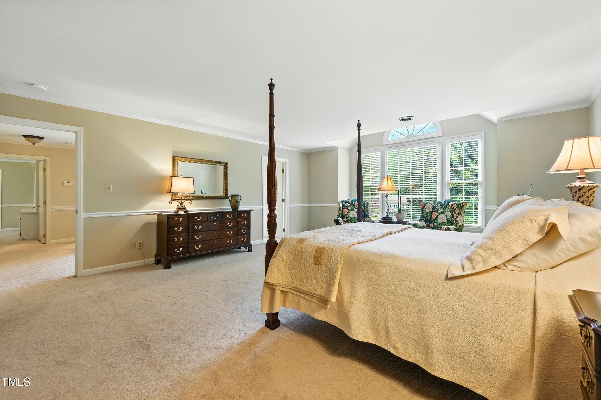 5317 Deep Valley Raleigh, NC 27606 - Photo 43 of 59 a bed sitting in a spacious bedroom next to a window
