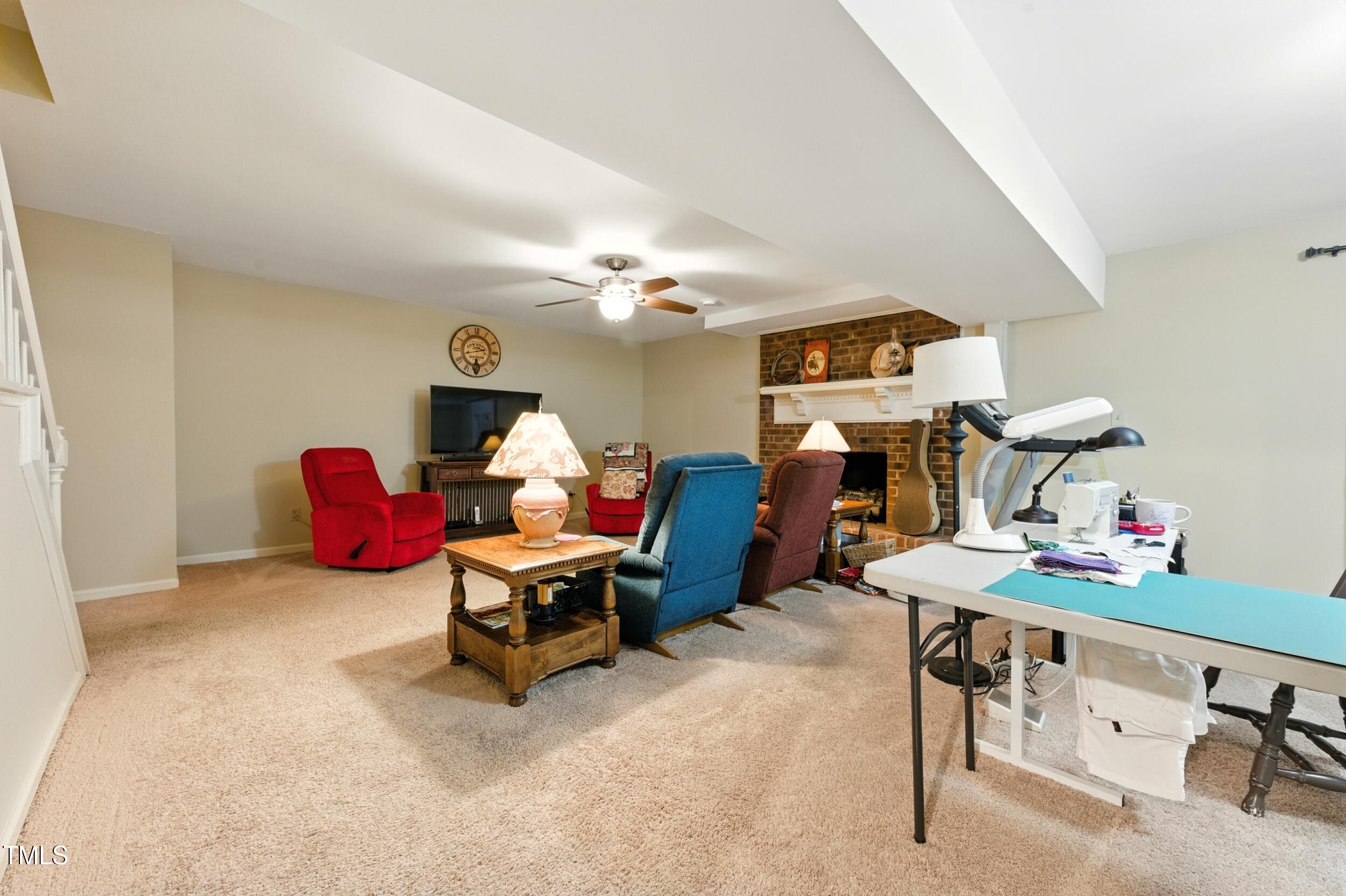 5317 Deep Valley Raleigh, NC 27606 - Photo 47 of 59 a living room with furniture and a flat screen tv