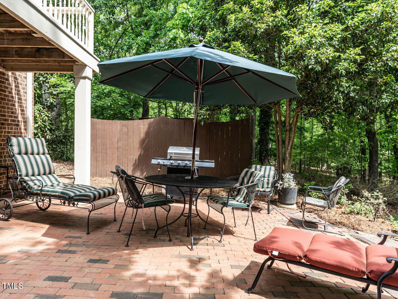 5317 Deep Valley Raleigh, NC 27606 - Photo 49 of 59 a view of patio with chairs and table under an umbrella