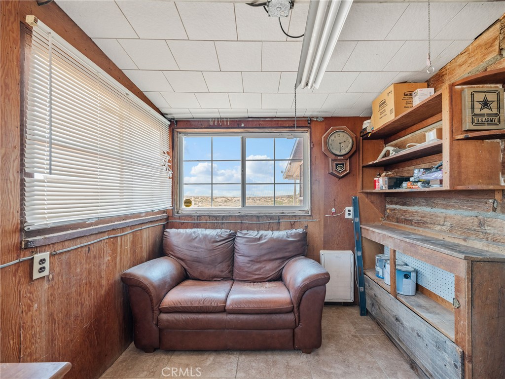 19876 Stoddard Wells Road Apple Valley, CA 92307 - Photo 14 of 40 a living room with furniture and a fireplace