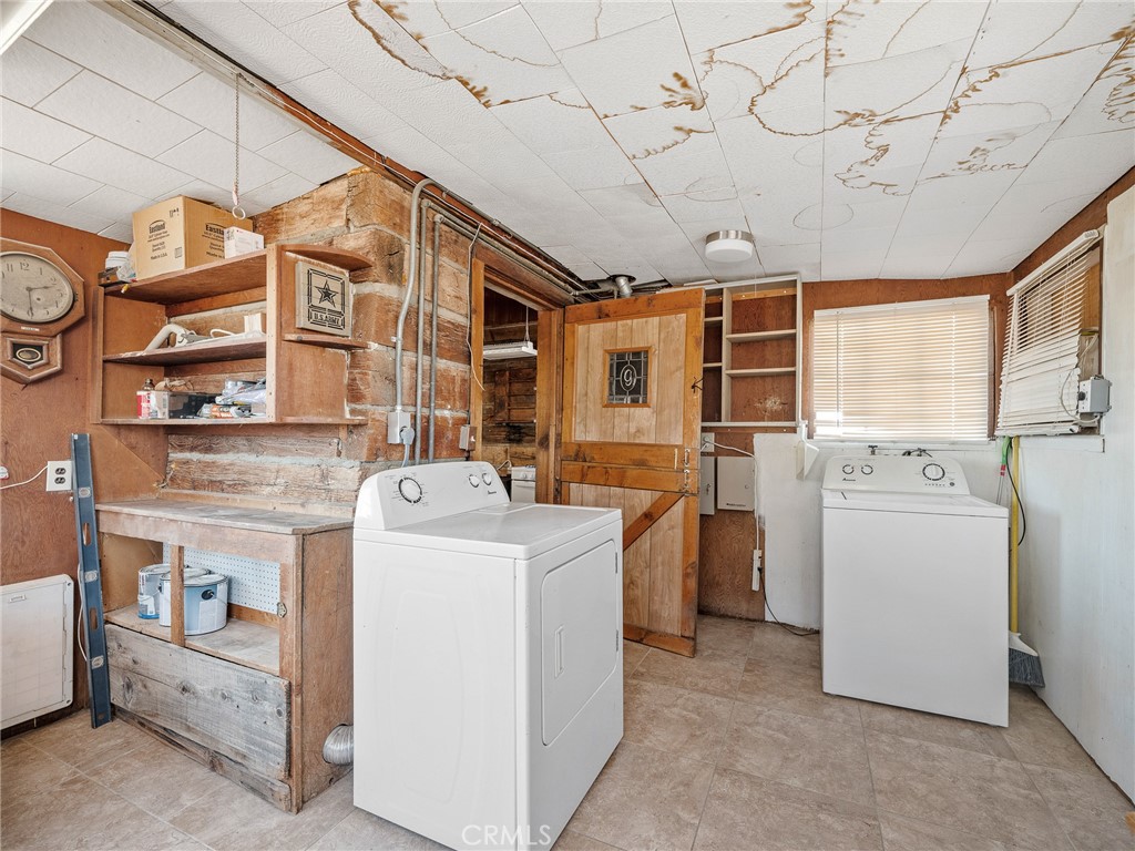 19876 Stoddard Wells Road Apple Valley, CA 92307 - Photo 15 of 40 a view of a storage & utility room with washer and dryer