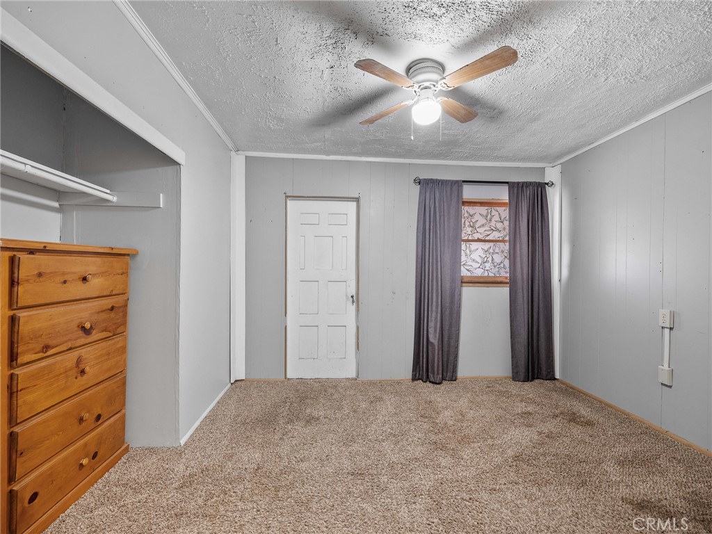 19876 Stoddard Wells Road Apple Valley, CA 92307 - Photo 19 of 40 a view of a bedroom with closet and cabinet