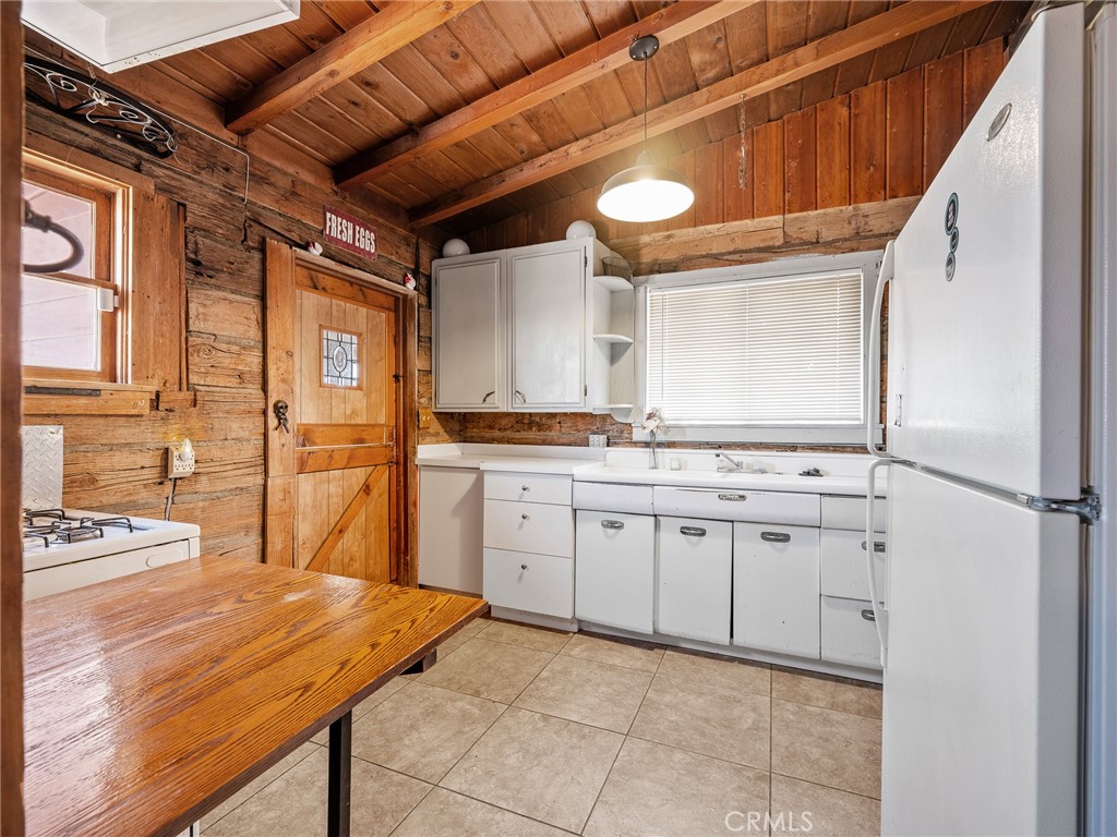 19876 Stoddard Wells Road Apple Valley, CA 92307 - Photo 10 of 40 a kitchen with cabinets and wooden floor